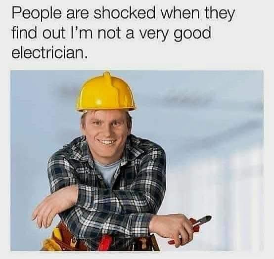 A man wearing a yellow hard hat and plaid shirt, holding pliers and smiling confidently while leaning on a tool belt, with…