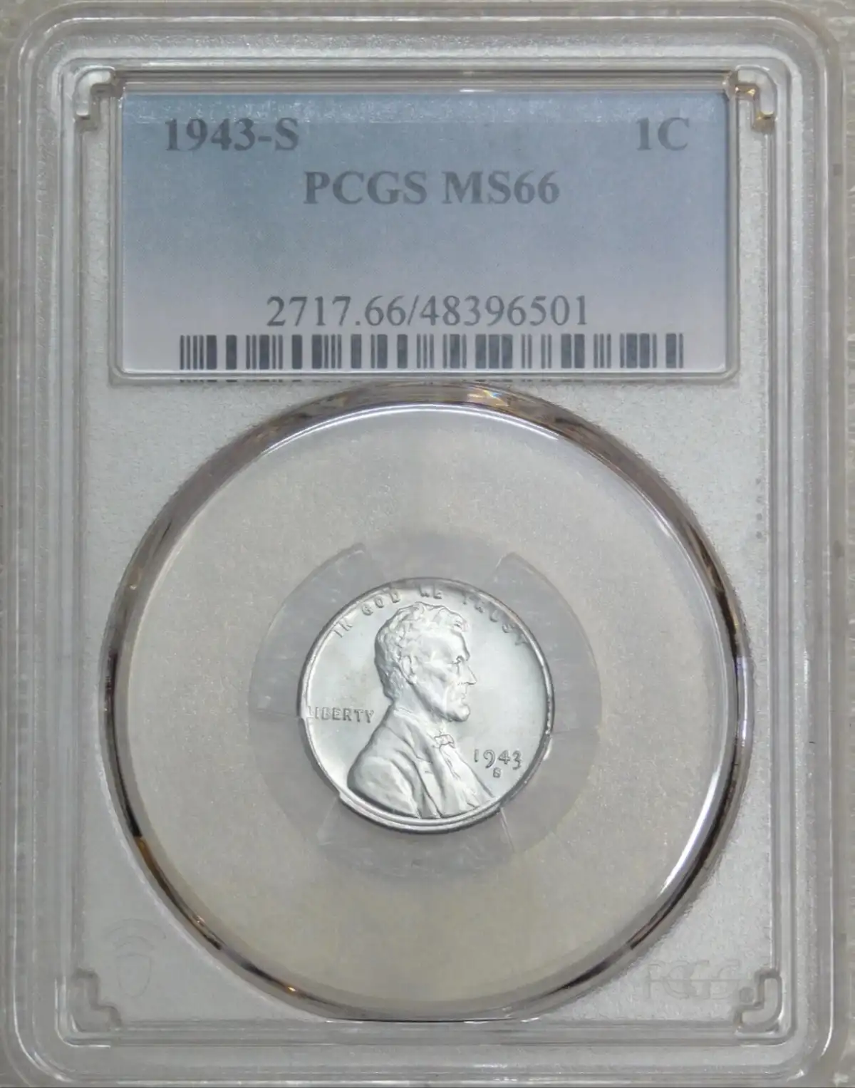 A 1943-S Lincoln cent is displayed in a PCGS grading slab, labeled MS66, with a barcode and serial number. The coin itself…