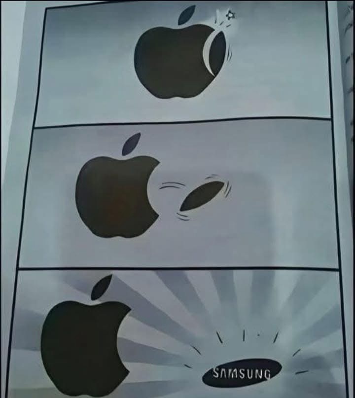 A three-panel comic strip shows a black Apple logo being hit by a bullet in the first panel, then having a bullet hole in…