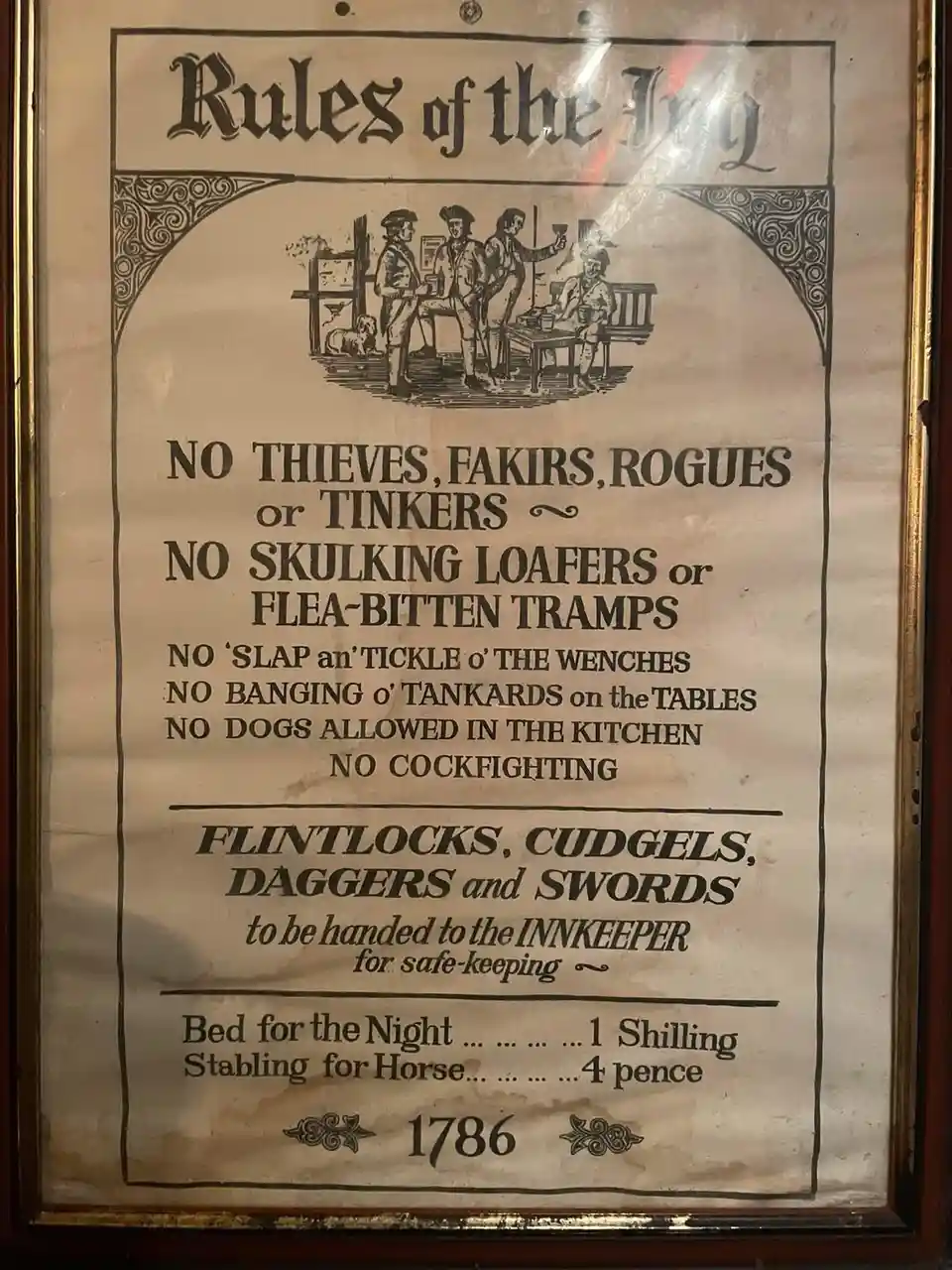A framed, vintage-style poster titled 'Rules of the Inn' from 1786, featuring an illustration of men in historical attire…