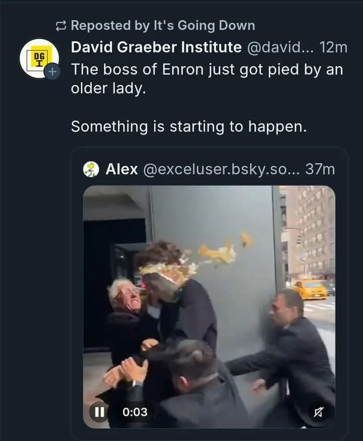A screenshot of a social media post showing a video clip where an older woman throws a pie at a man in a suit, who is being…