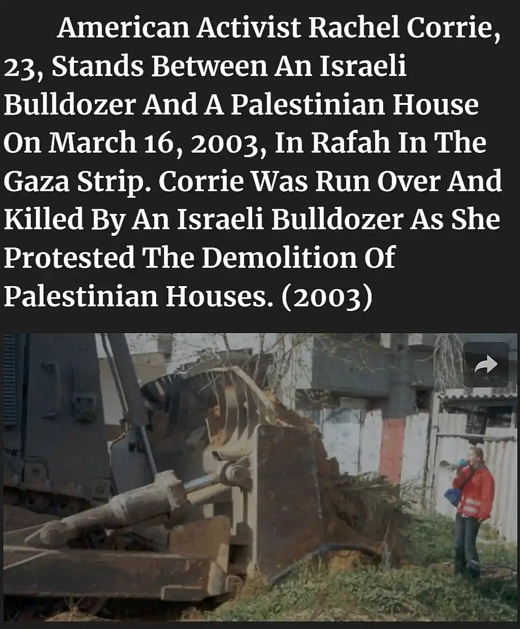 A photograph shows a young woman in a red jacket standing beside a large, rusty bulldozer that is demolishing a structure…