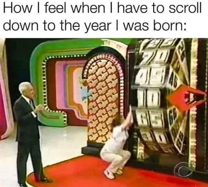 A woman in a white outfit is crouched and reaching up desperately at a large, ornate, retro-style year display that shows…