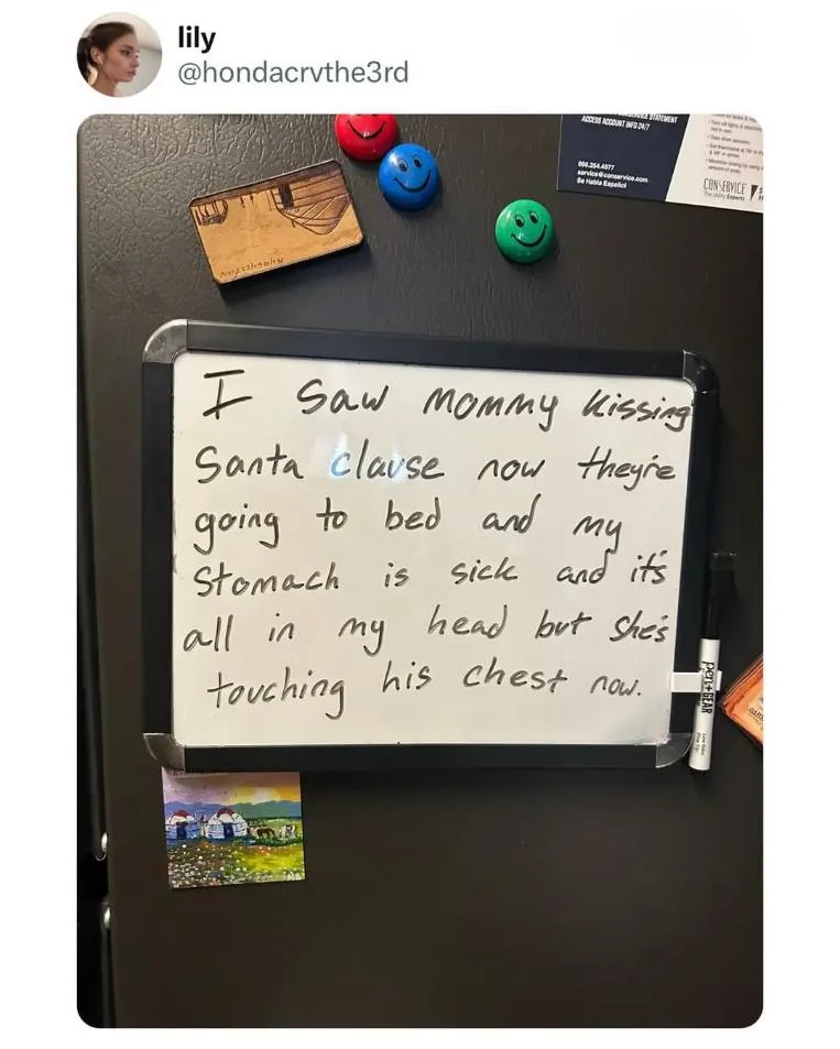 A whiteboard magnet on a black refrigerator displays handwritten text describing a child's innocent but confusing…