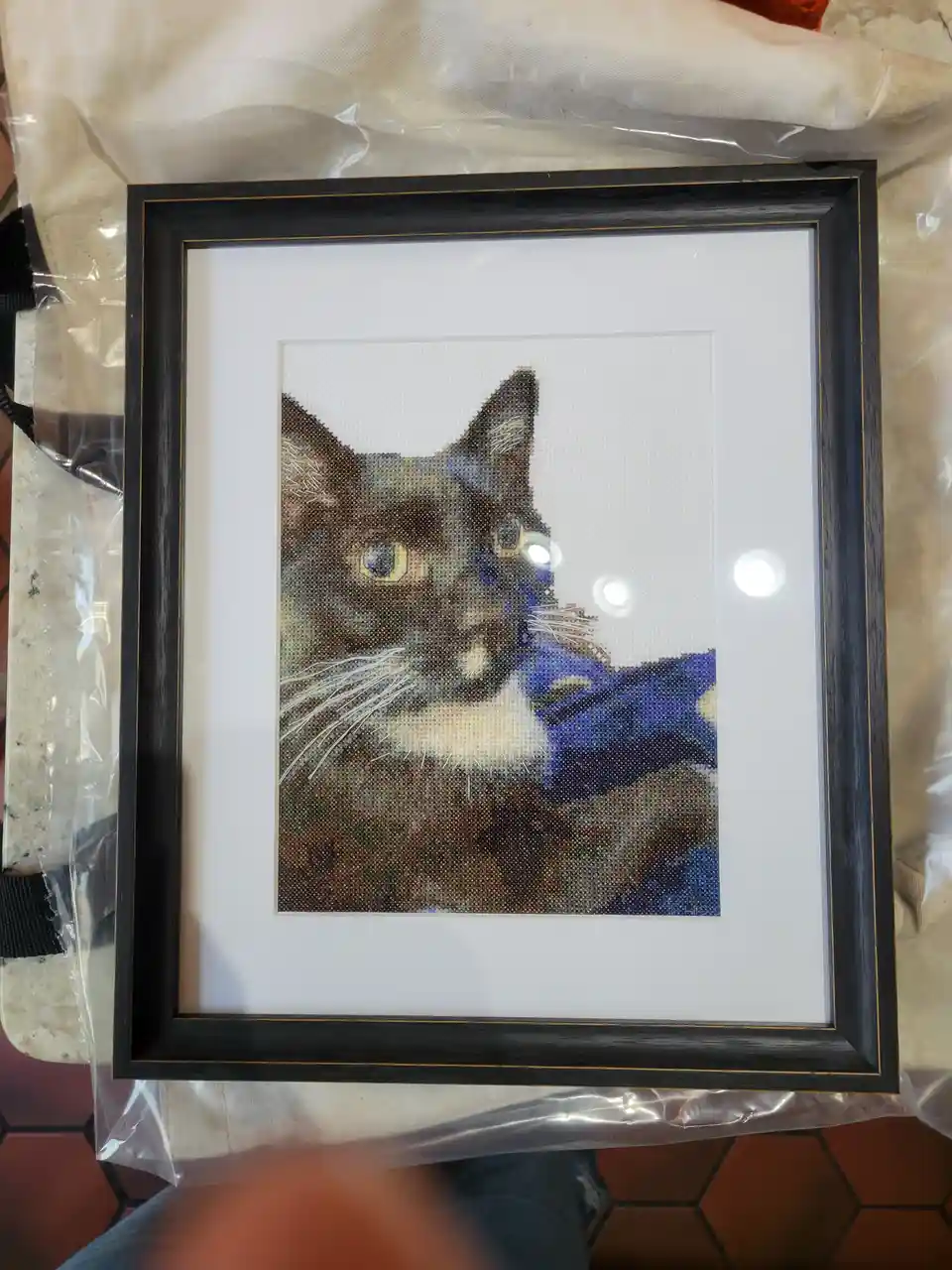 A beautifully framed cross stitch masterpiece