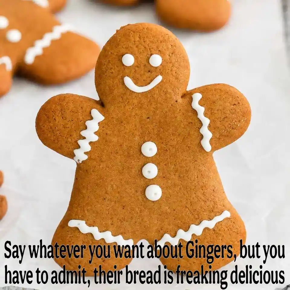 A close-up photo of a smiling gingerbread cookie decorated with white icing buttons and borders, with other similar cookies…