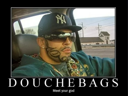 A man with a tattooed beard, wearing a New York Yankees cap and sunglasses, sits in a car. The image has bold white text at…