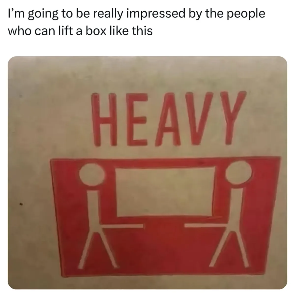 A red warning sticker shows the word 'HEAVY' above a pictogram of two stick figures lifting a box together. The overlaid…