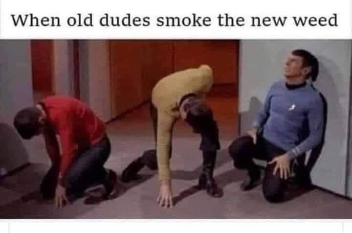 Three men in Star Trek uniforms are kneeling on the floor in a hallway, each in progressively more exaggerated states of…