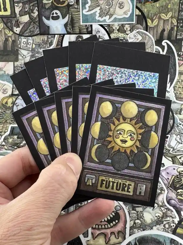 A hand holds a fanned-out set of identical fortune-telling cards, each featuring a smiling anthropomorphic sun surrounded by…