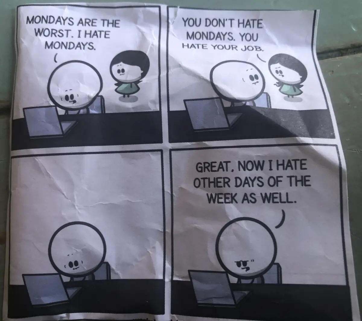 A four-panel comic strip shows two cartoon characters at desks with laptops. The first panel has a character saying 'MONDAYS…