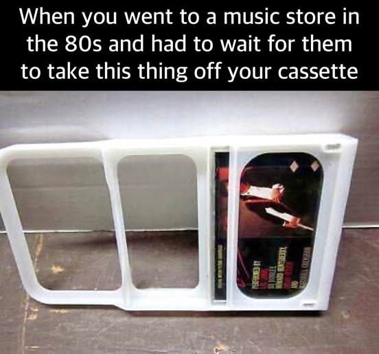 A white plastic cassette tape case with a visible cassette tape inside, featuring an album cover with a person holding a…