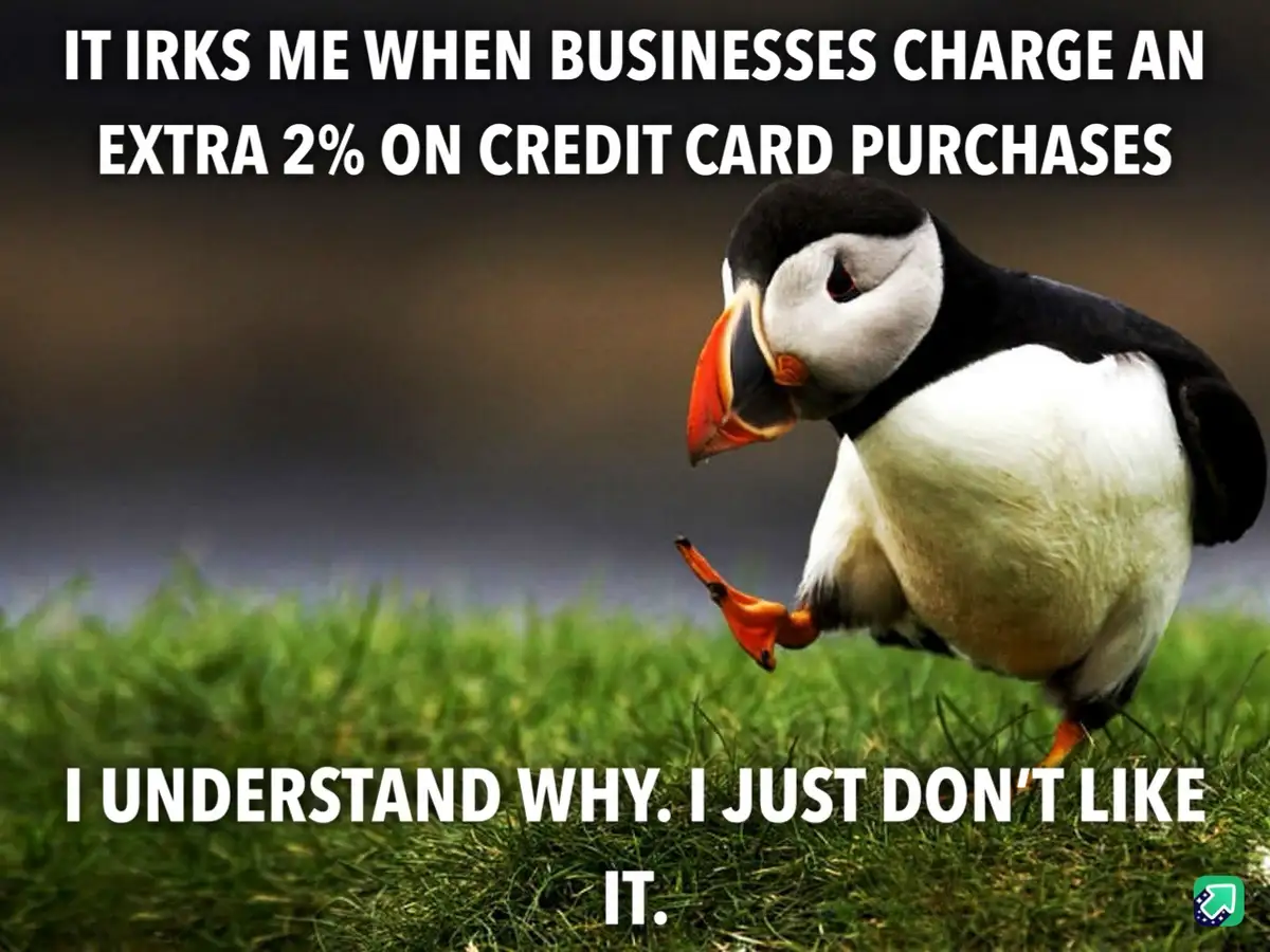 A photograph of a puffin standing on green grass with a blurred background, looking annoyed. White bold text at the top…