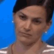 The image displays six identical frames of a woman with dark hair pulled back, wearing small earrings and a striped top…
