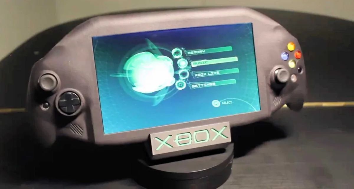 A gray handheld gaming device resembling an Xbox console, displayed on a stand with a glowing green 'XBOX' logo. The screen…