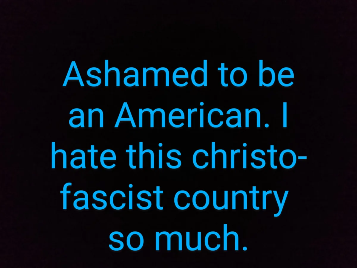 The image displays bold, glowing blue text centered on a dark, textured background. The text reads: 'Ashamed to be an…