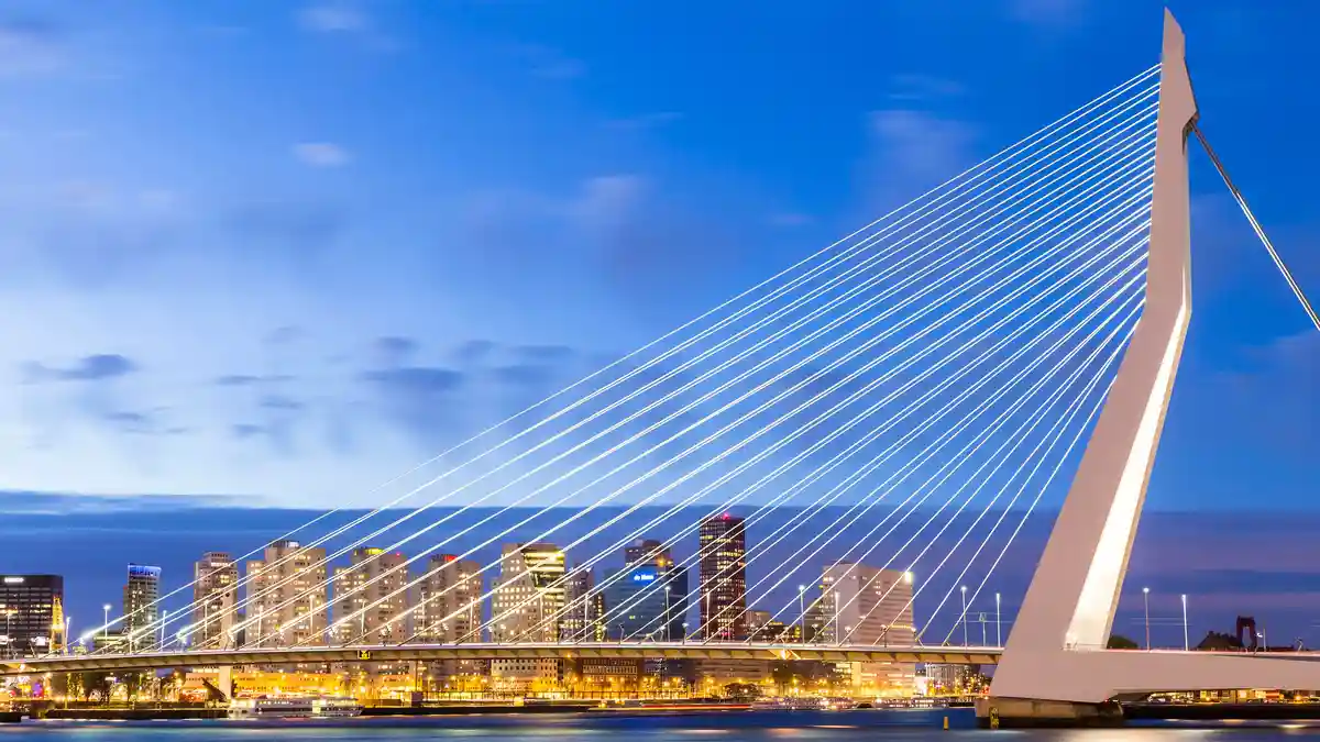 Rotterdam's city center, rebuilt after WWII, boasts a modern skyline. The Erasmusbrug, a striking 'harp' structure…