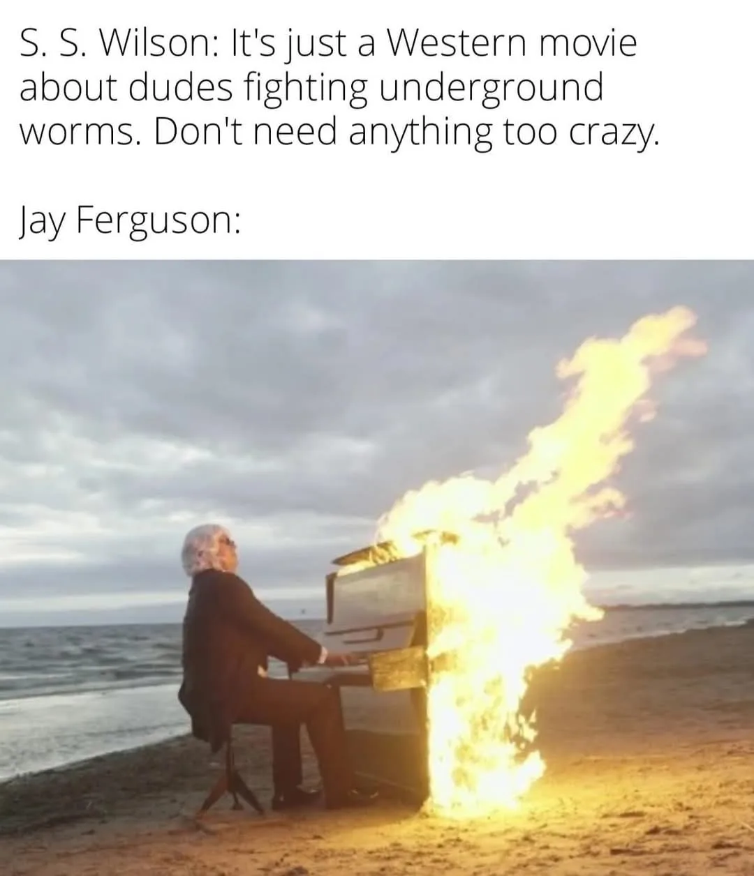 An older man with white hair sits at a piano on a beach, playing as the instrument bursts into flames. The text above reads…