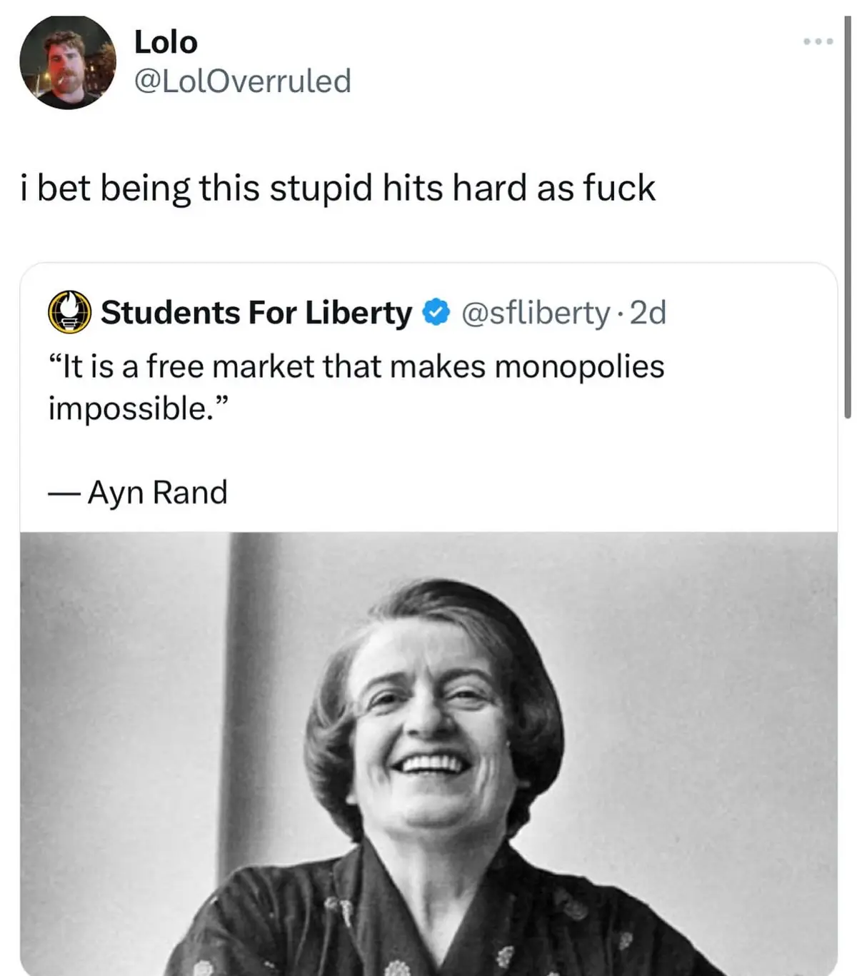 A black-and-white photo of Ayn Rand smiling broadly is overlaid with text showing a tweet from 'Students For Liberty' that…