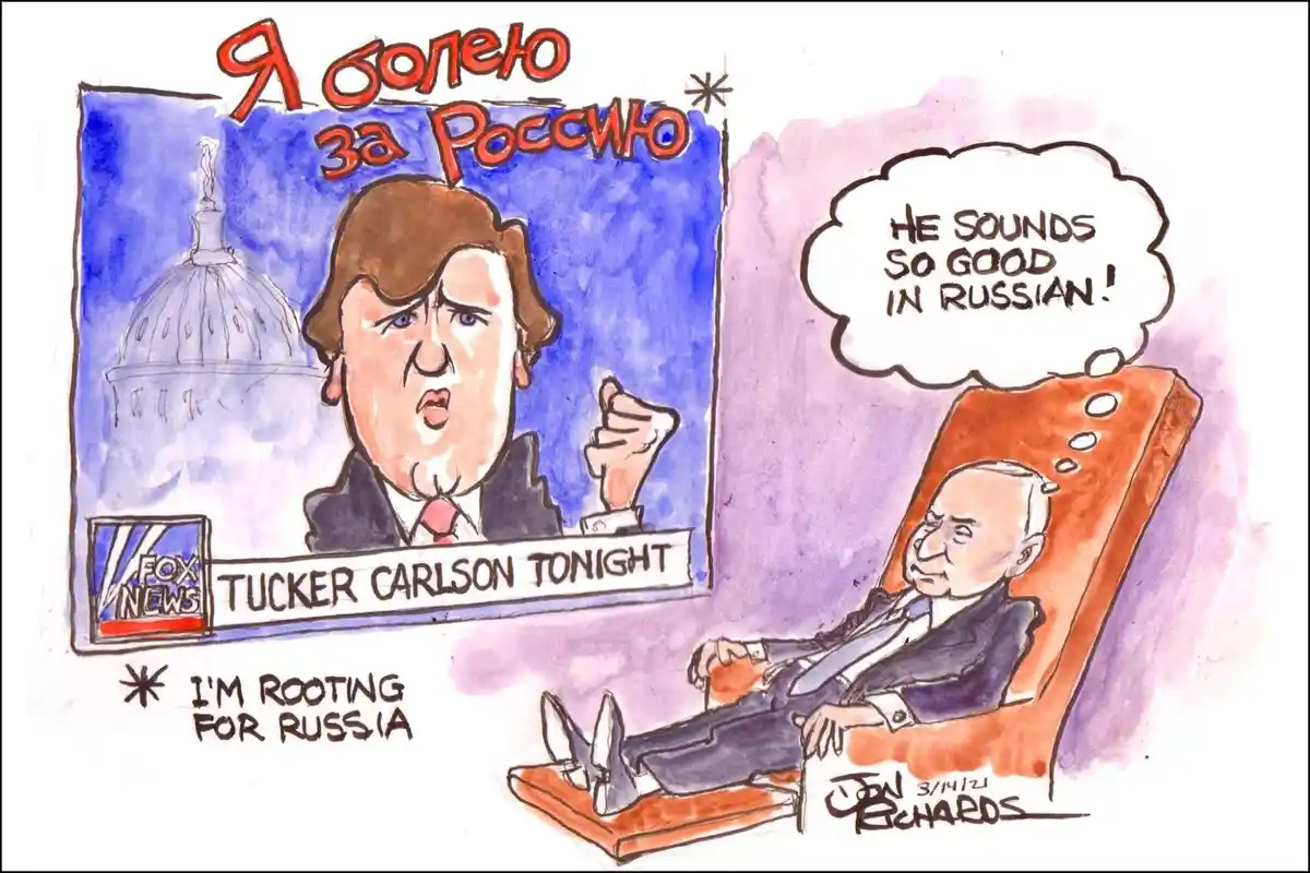 A cartoon shows Vladimir Putin lounging in a chair, watching a TV screen displaying Tucker Carlson on Fox News. The screen…