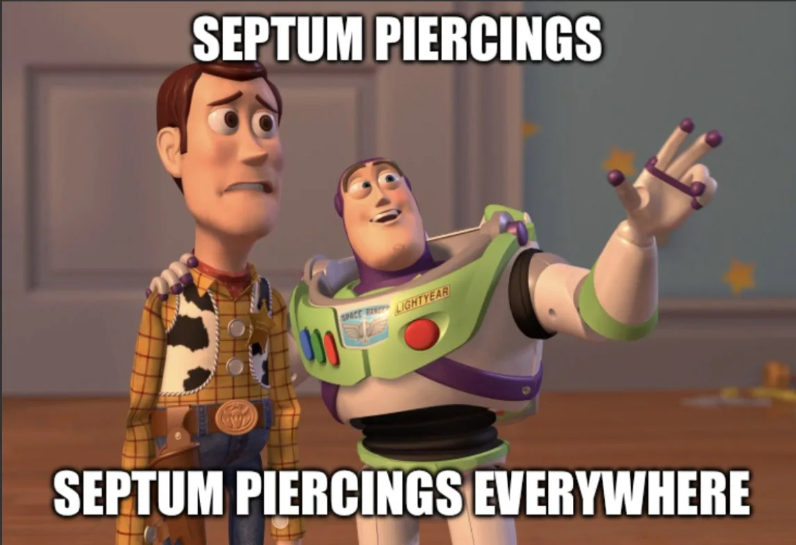 Two animated characters, Woody and Buzz Lightyear from Toy Story, are shown. Buzz has purple septum piercings and is…