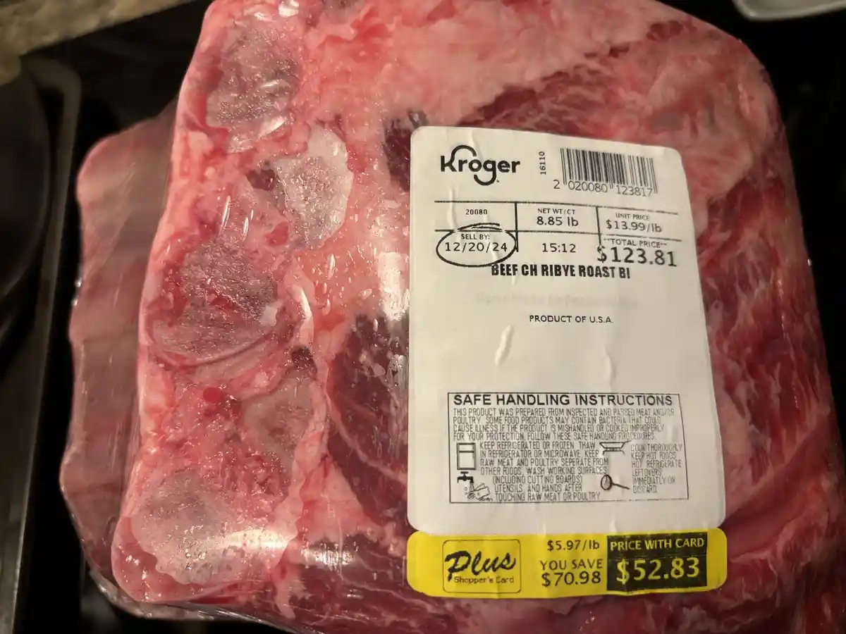 A close-up photo of a Kroger-branded beef chuck roast in plastic packaging, showing a price tag with a total price of…