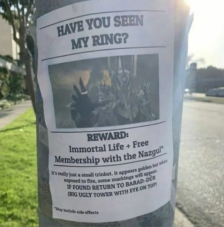 A 'lost ring' flyer is taped to a tree, mimicking a real missing person poster. The image shows a gloved hand holding a…