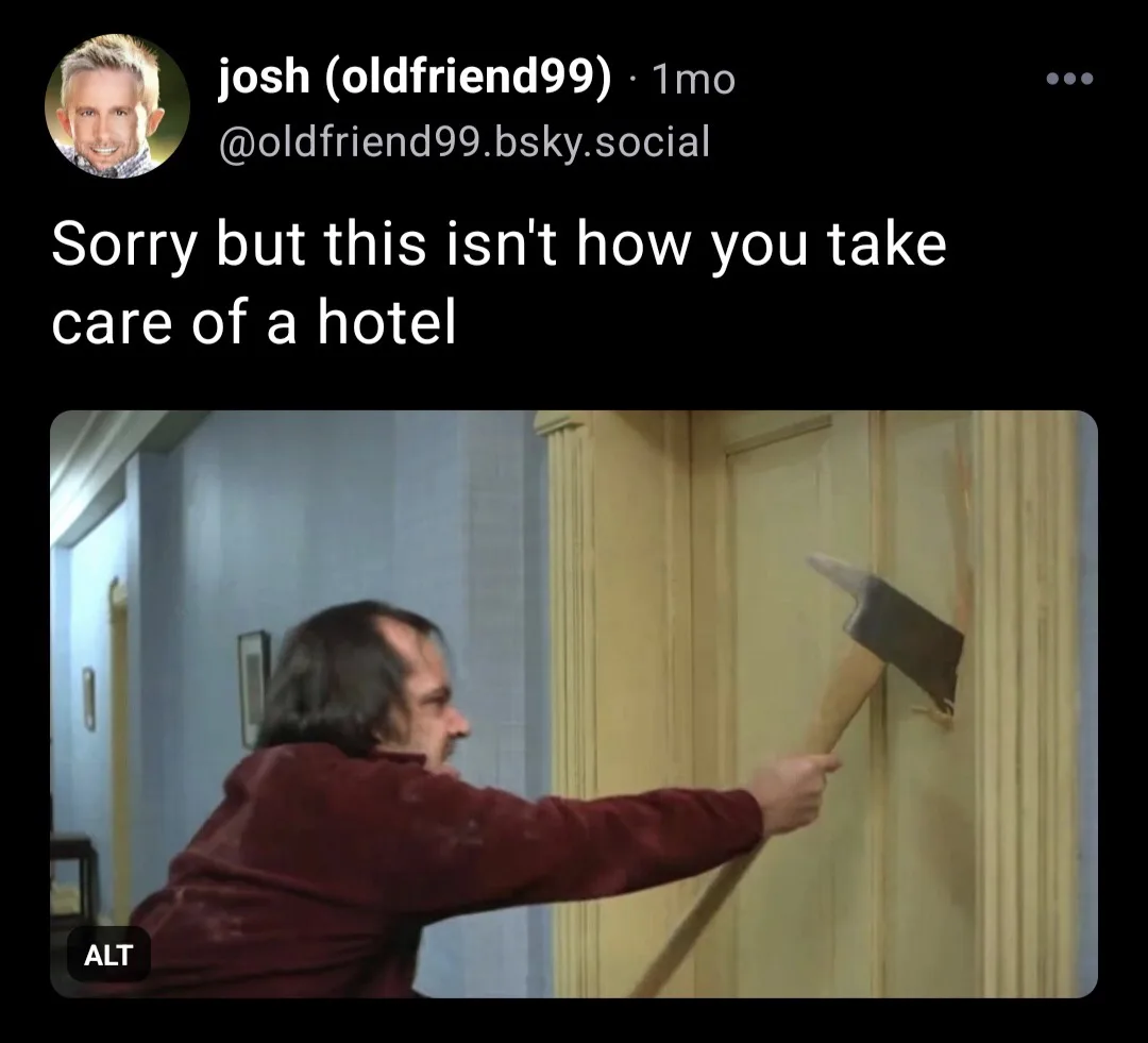 A man in a maroon shirt is shown swinging an axe at a wooden hotel door, visibly damaging it. The overlaid text reads 'Sorry…