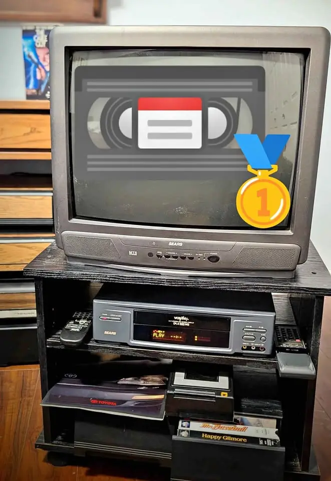 An old CRT television displays a graphic of a VHS tape with a digital calendar icon overlaid, and a gold medal with the…