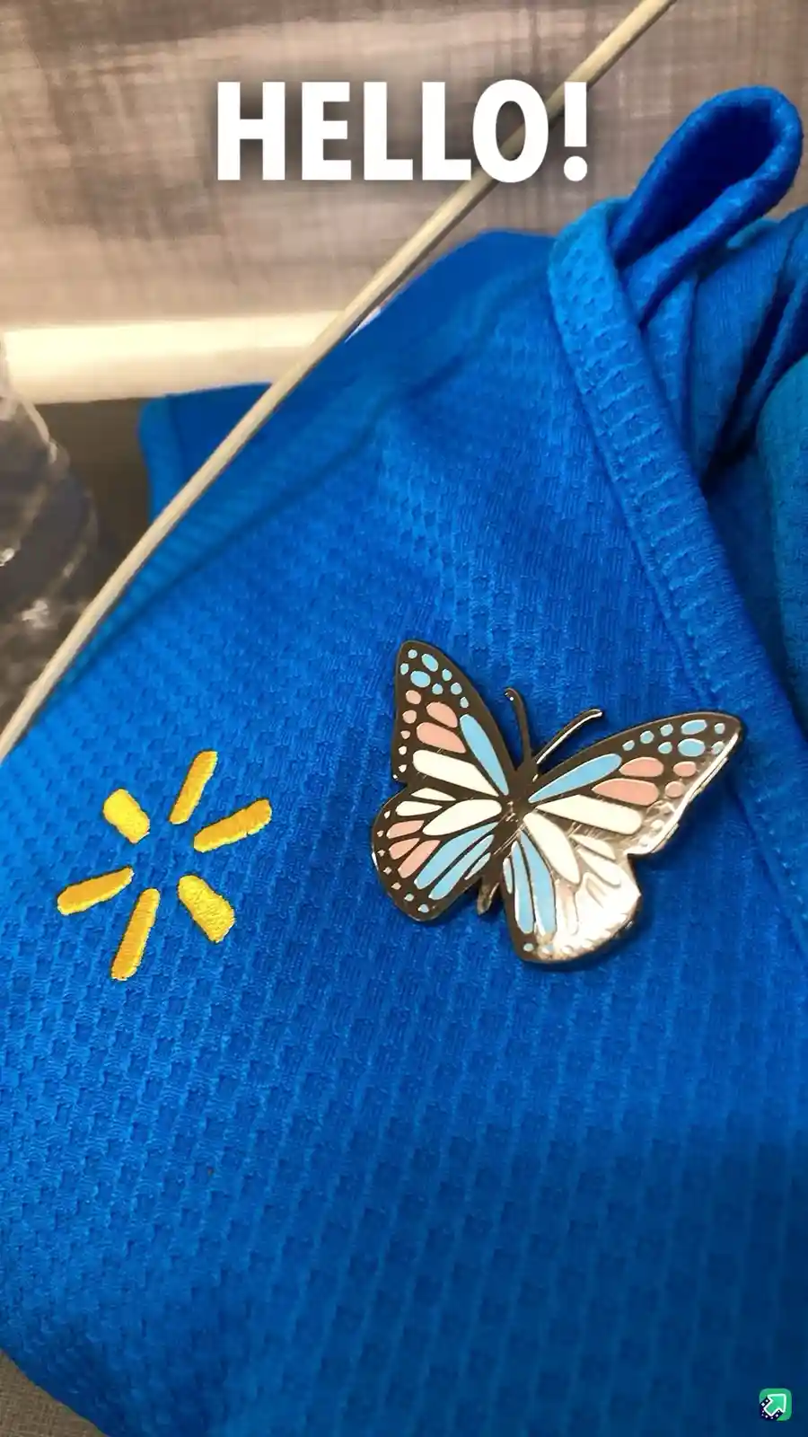 A close-up photo shows a blue Walmart employee polo shirt with the yellow Walmart logo embroidered on the left chest. Next…
