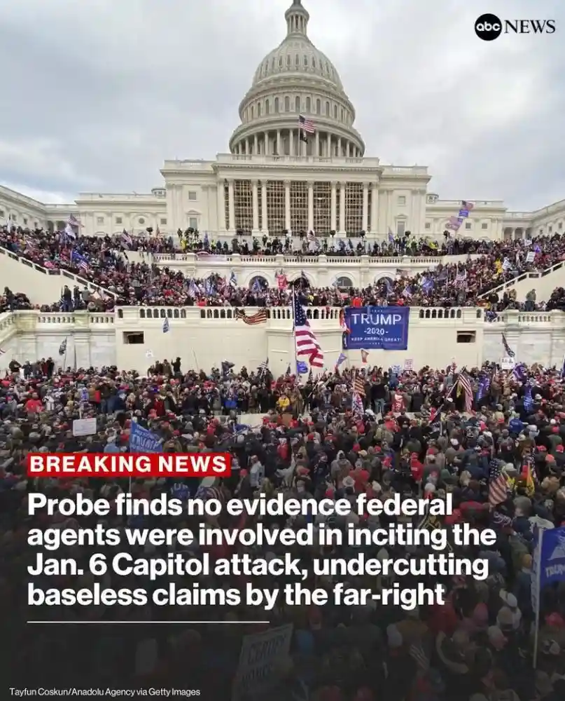 A large crowd of people, many wearing red hats and holding American flags and 'TRUMP 2020' signs, is gathered on and around…