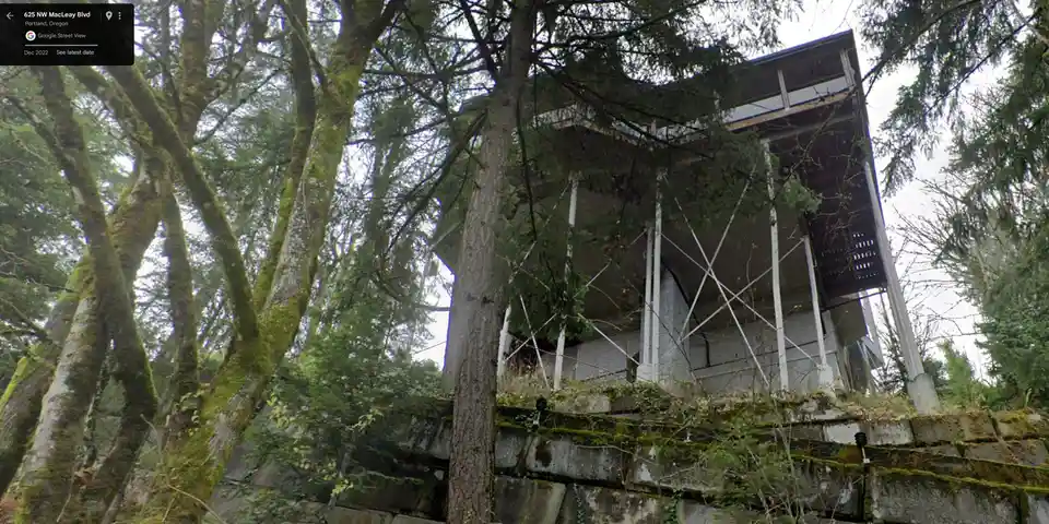 a google street view image of a house at 625 nw macleay blvd in portland, oregon, surrounded by tall moss-covered trees and…