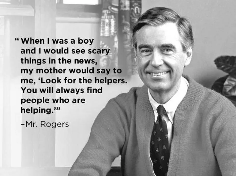 A black-and-white photo of Mr. Rogers smiling, wearing a cardigan over a collared shirt and tie, with a quote overlaid on…