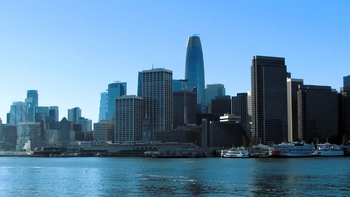 A scenic photo of the San Francisco skyline with the Salesforce Tower prominently visible, viewed from across the water…