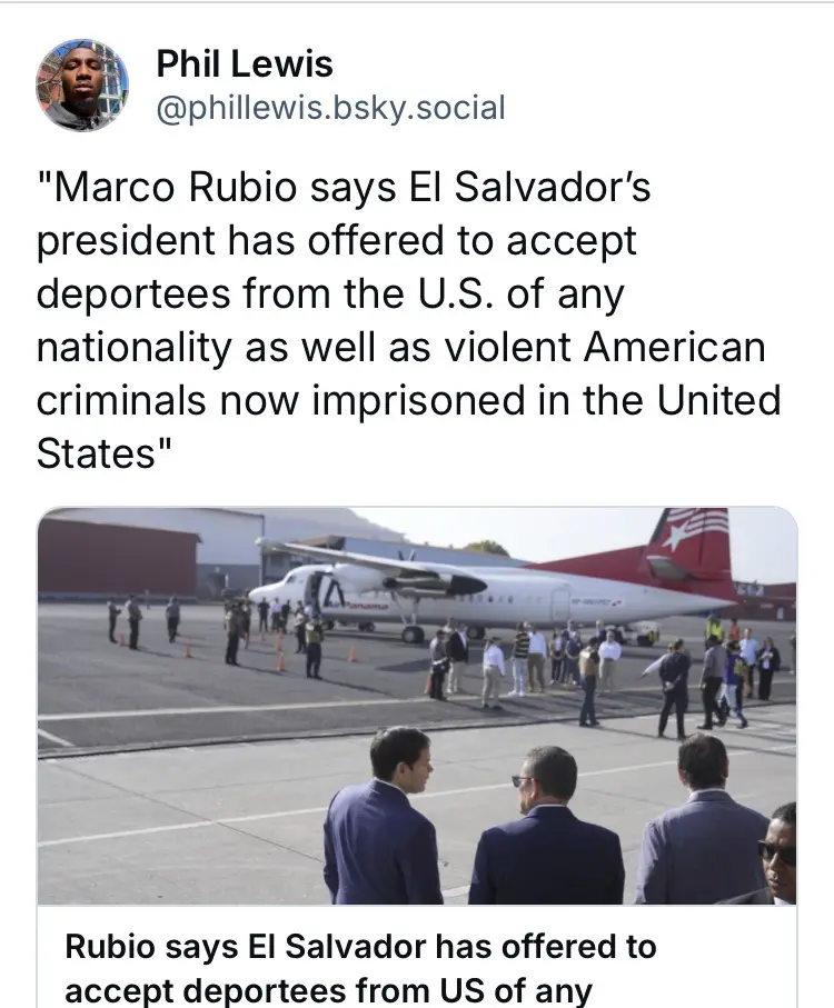 A screenshot of a social media post by Phil Lewis showing a photo of several men in suits standing on an airport tarmac…