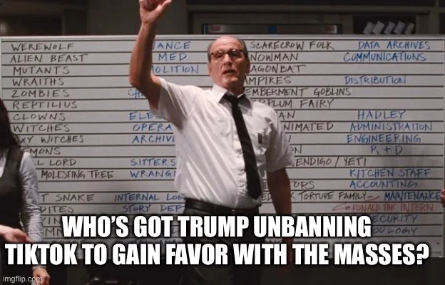 A man in a white shirt and tie stands in front of a whiteboard covered in handwritten monster names like 'WEREWOLF'…