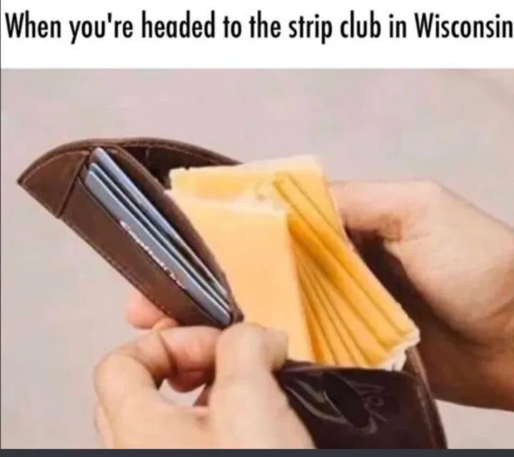 A person opens a brown leather wallet to reveal it is filled with slices of cheese instead of cash. The overlaid text reads…