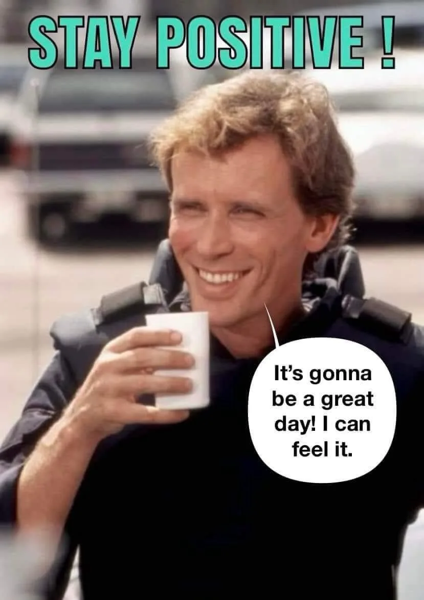 A man with a wide, optimistic smile holds a white mug while wearing a dark jacket with shoulder pads. Large teal text at the…