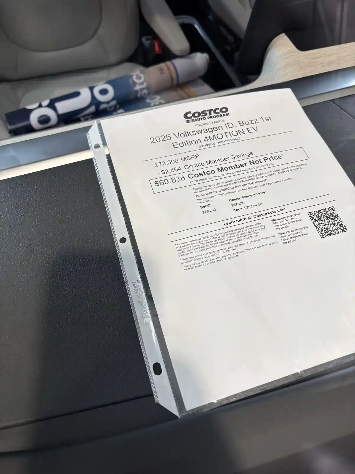 A close-up photo of a Costco Auto Program pricing document for a 2025 Volkswagen ID. Buzz 1st Edition 4MOTION EV, resting on…
