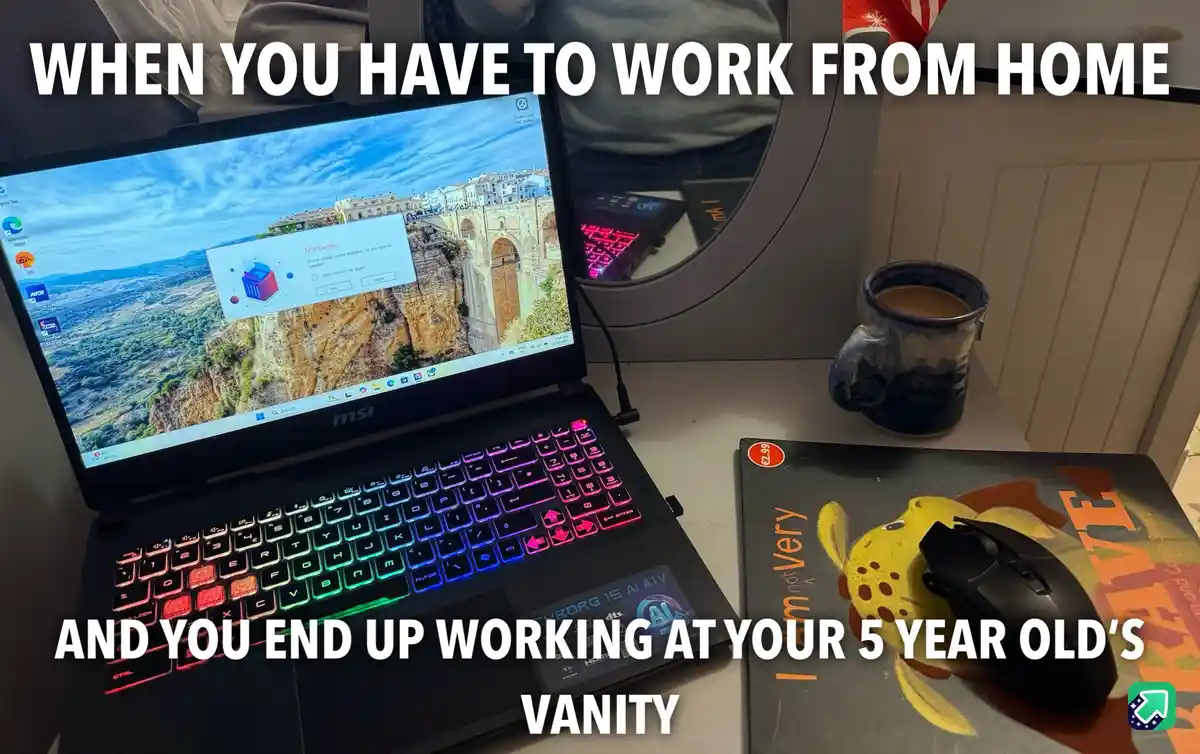 A laptop with a colorful backlit keyboard sits on a desk next to a mug and a mouse on a mousepad featuring a cartoon…