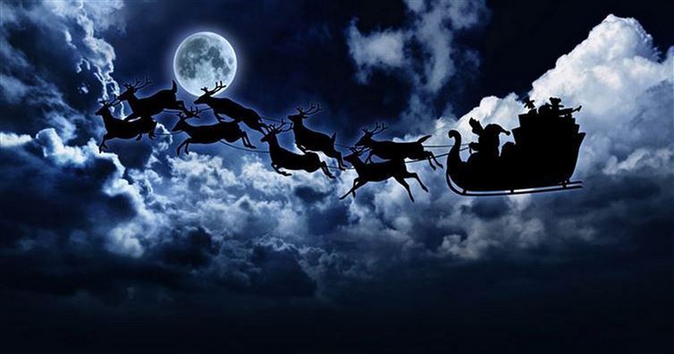 A dark, dramatic night sky with a full moon and swirling clouds, featuring the silhouette of Santa Claus in his sleigh being…