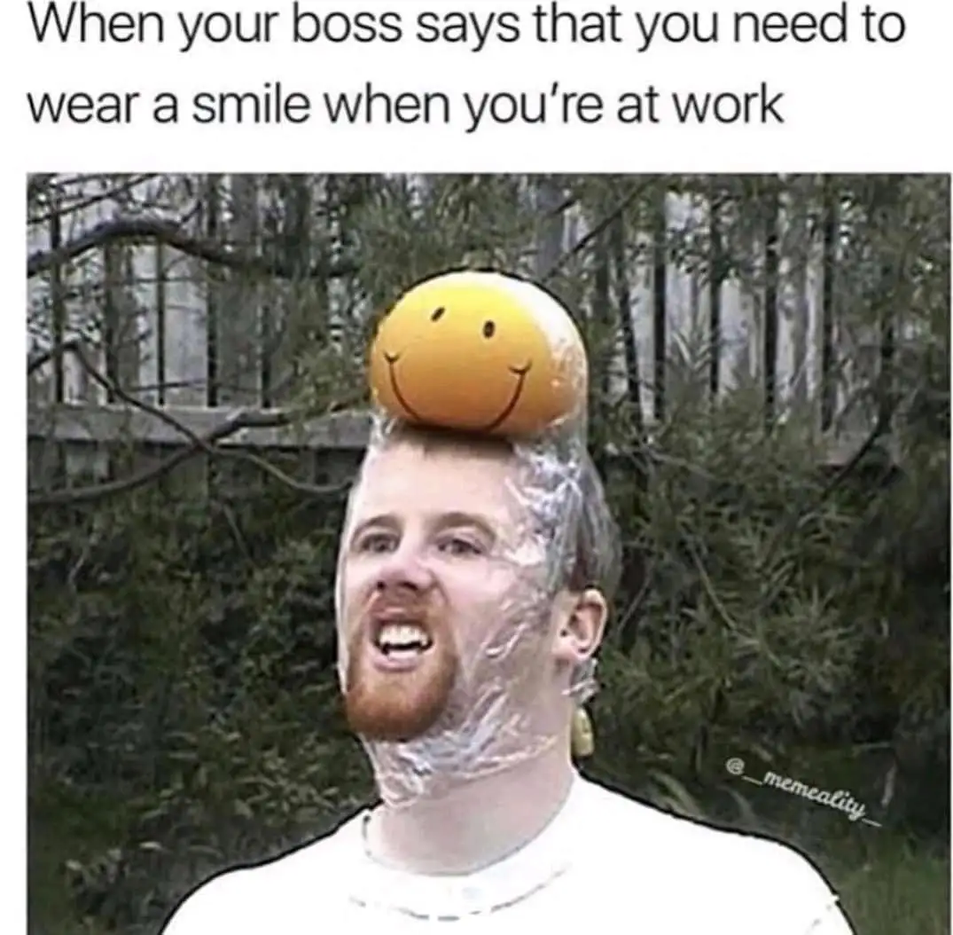 A man with plastic wrap stuck to his face and head, with a yellow smiley face balloon balanced precariously on top of his…
