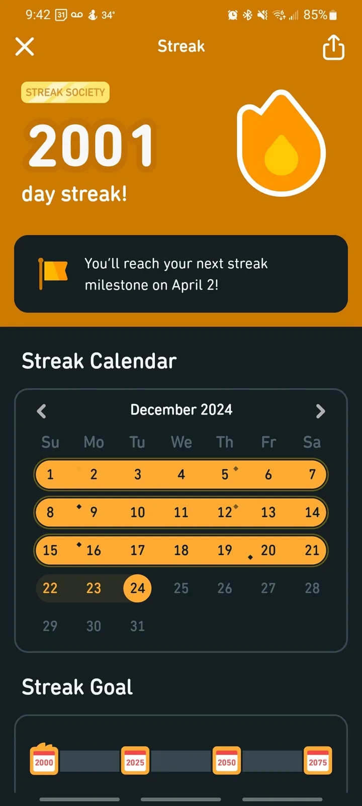 A screenshot of a streak-tracking app showing a 2001-day streak milestone with a flame icon. The calendar displays December…