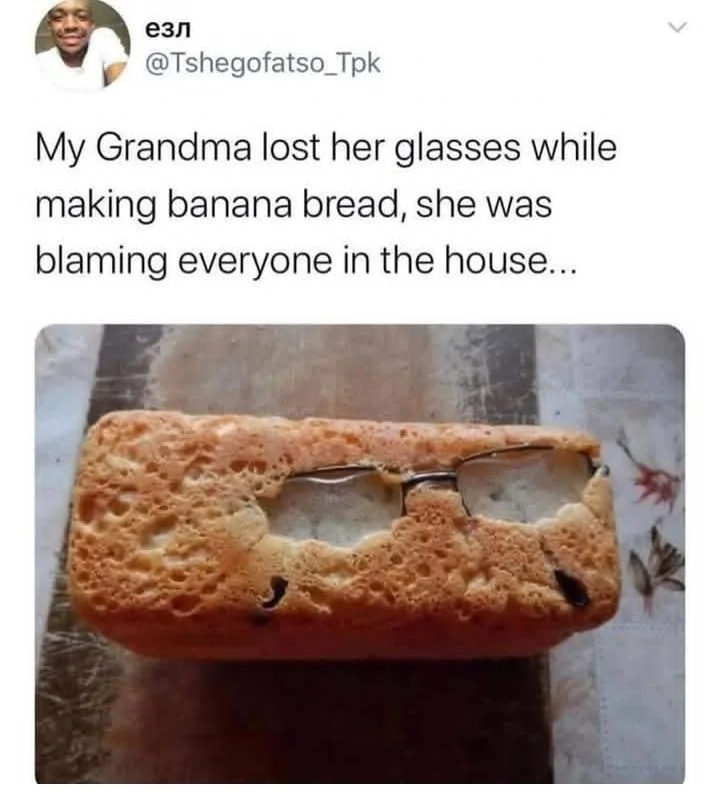 A loaf of banana bread with a pair of eyeglasses embedded in its center, as if baked into it. The text above the image…