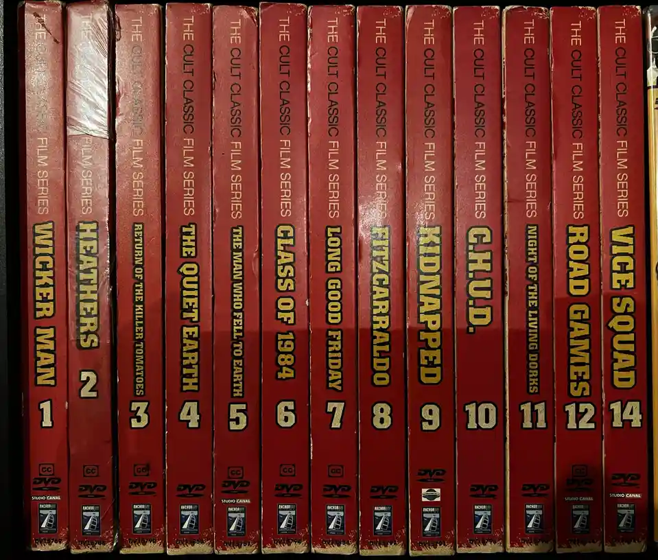 A row of red DVD cases from 'The Cult Classic Film Series' are shown spine-out, displaying titles like 'Wicker Man 1'…