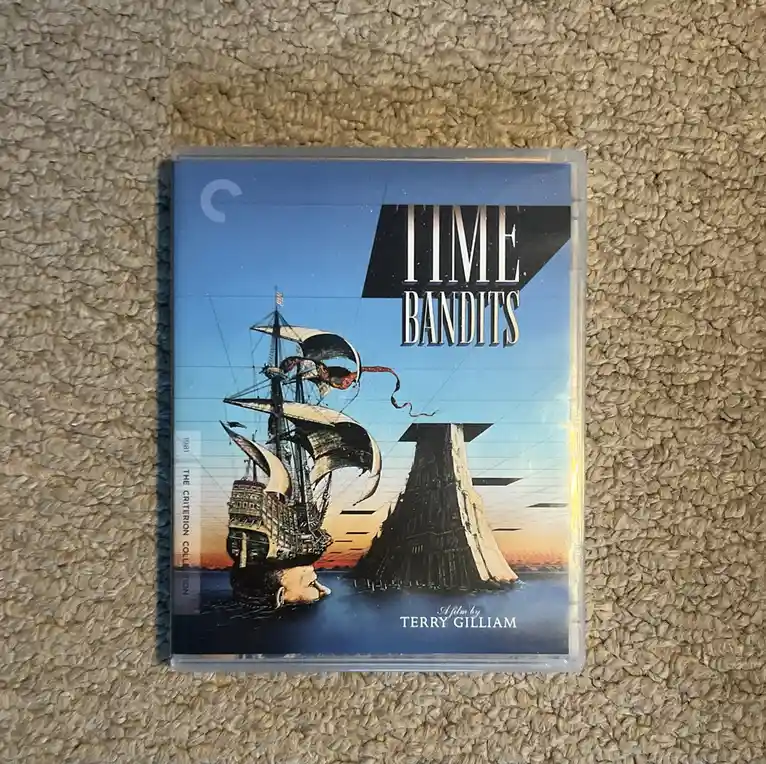 A Criterion Collection DVD case for the 1981 film 'Time Bandits' by Terry Gilliam, featuring a surreal cover art of a…