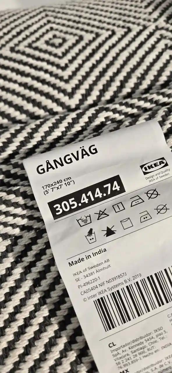 A close-up photo of an IKEA product tag for a rug named 'GÅNGVÄG' with dimensions 170x240 cm and price 305.414.74, placed on…