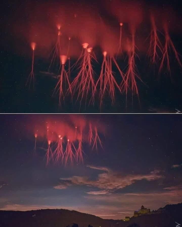 The image displays two nearly identical photos of red fireworks exploding in the night sky, with the top photo showing only…