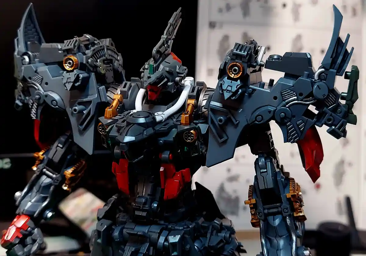 A close-up photo of a highly detailed, grey, red, and gold robot model with intricate mechanical parts and angular armor…