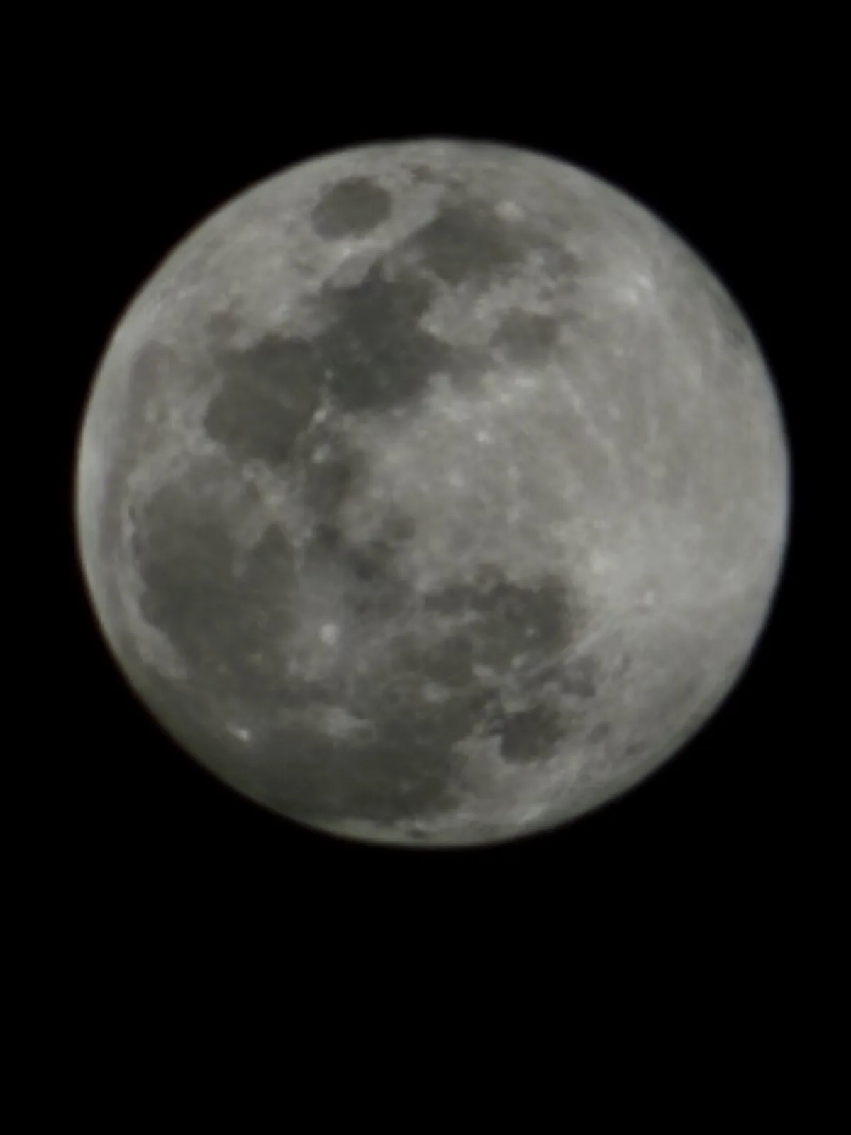 A close-up photograph of the moon against a black sky, showing its cratered surface in shades of gray. Overlaid text reads…
